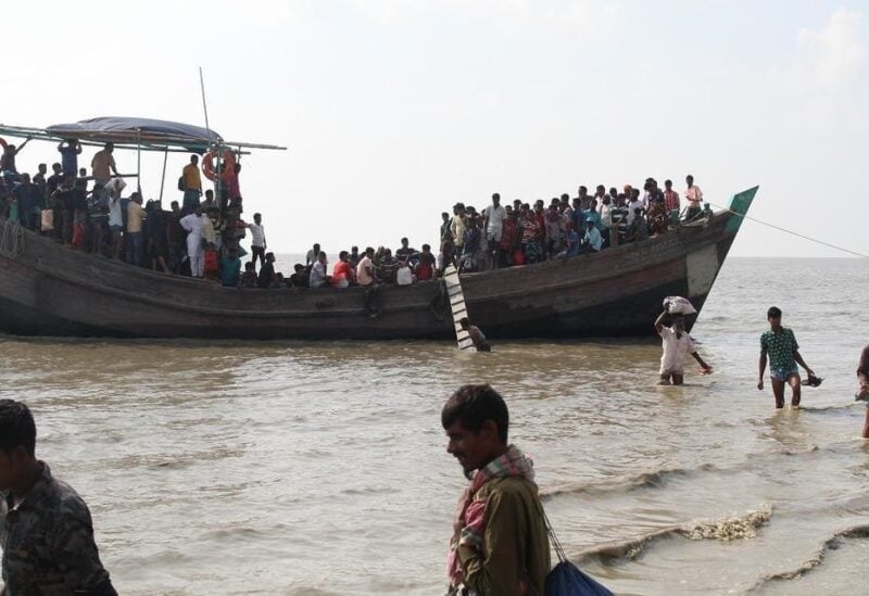 People get off a boat in Bhashan Char island off the Bangladeshi coast, as it was being prepared for the relocation of Rohingya refugees living in the country's south. (File photo: AFP)