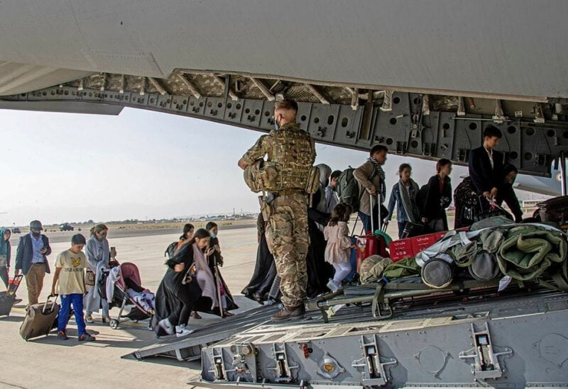 British citizens and dual nationals residing in Afghanistan board a military plane for evacuation from Kabul airport, Afghanistan August 16, 2021, in this handout picture obtained by Reuters on August 17, 2021. LPhot Ben Shread/UK MOD Crown copyright 2021/Handout via REUTERS THIS IMAGE HAS BEEN SUPPLIED BY A THIRD PARTY. MANDATORY CREDIT. NO RESALES. NO ARCHIVES. FACES BLURRED AT SOURCE