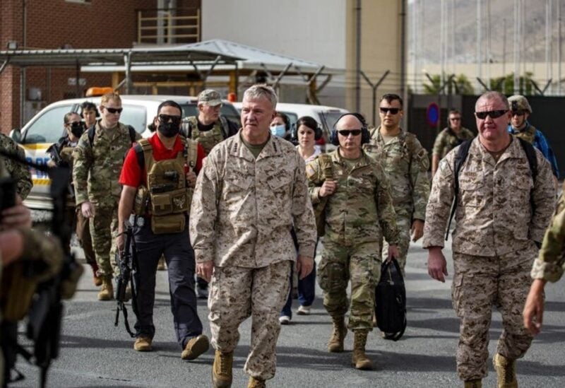 This US Marine Corps photo released on August 18, 2021 shows Commanding General US Central Command Kenneth F. McKenzie touring an evacuation control center at Hamid Karzai International Airport, Afghanistan, on August 17,2021. (AFP)