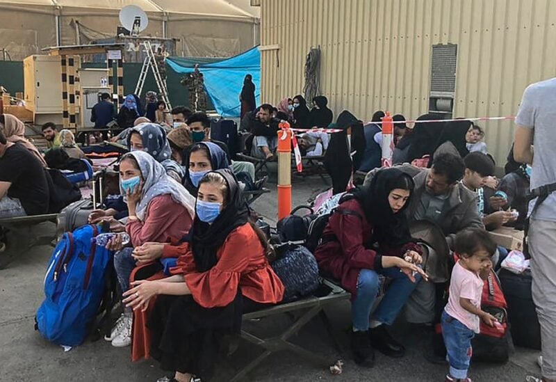 People wait to be evacuated from Afghanistan at the airport in Kabul on August 18, 2021 following the Taliban stunning takeover of the country. (File photo)
