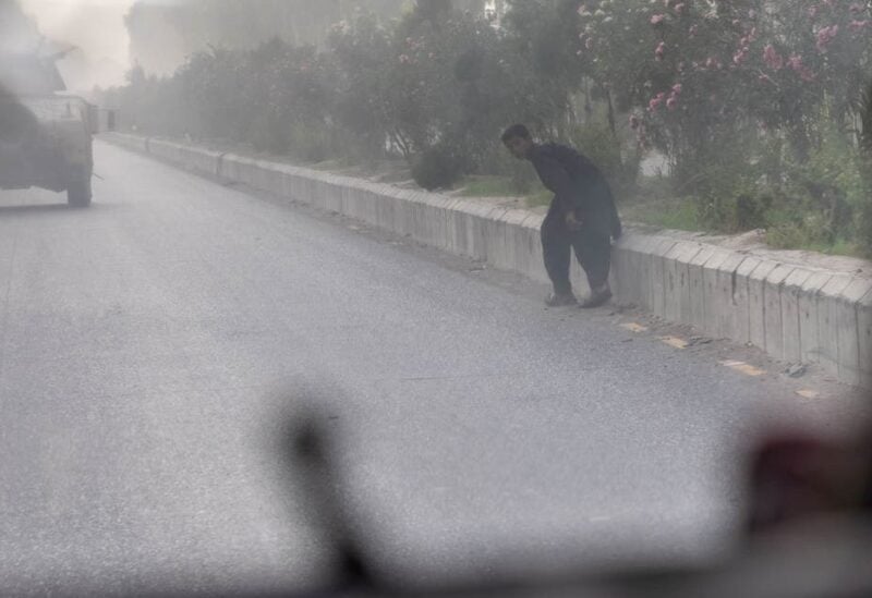 A civilian runs for cover as Afghan Special Forces and Taliban clash during the rescue mission of a police officer besieged at a check post, in Kandahar province, Afghanistan, July 13, 2021. (File photo: Reuters)