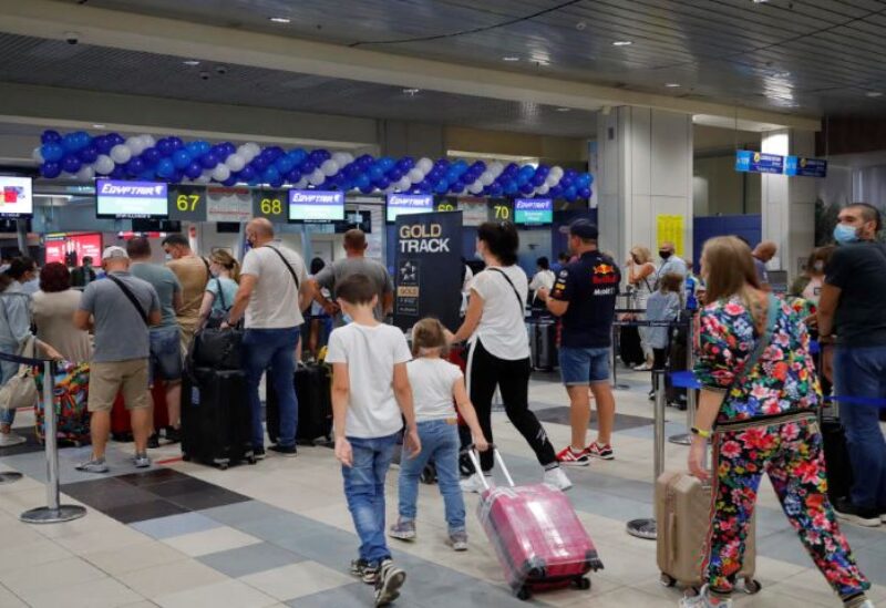 Russian tourists gather at the Egyptair check-in desk at the Domodedovo International Airport
