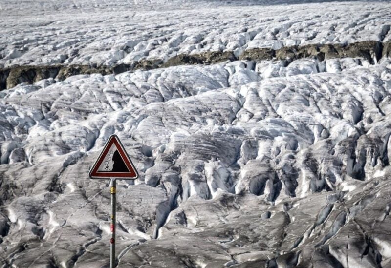 This picture taken on October 01, 2019 shows a warning sign for rockslide next to the Aletsch glacier above Bettmeralp, Swiss Alps. (Fabrice Coffrini/AFP)
