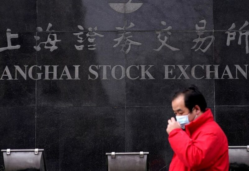 A man walks past the Shanghai Stock Exchange building at the Pudong financial district in Shanghai, China. (Reuters)