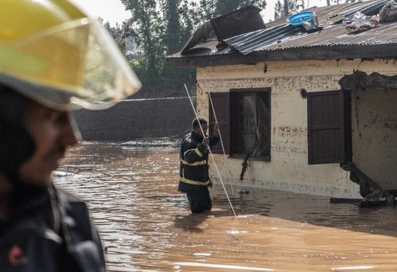 Fire fighters inspect damages caused by heavy rain which led to flood resident homes in Addis Ababa, Ethiopia, on August 18, 2021. (Amanuel Sileshi/AFP)