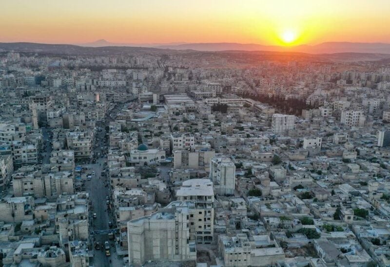 A drone picture taken on June 29, 2021, shows the sun setting over the opposition-held northwestern city of Idlib. (AFP)