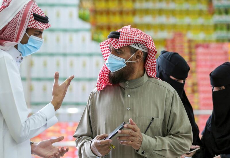A man displays his details on his mobile phone using the Tawakkalna app, which was launched by Saudi authorities to track people infected with the coronavirus disease (COVID-19), as he enters the Al-Othaim market in Riyadh, Saudi Arabia February 22, 2021. (Reuters)