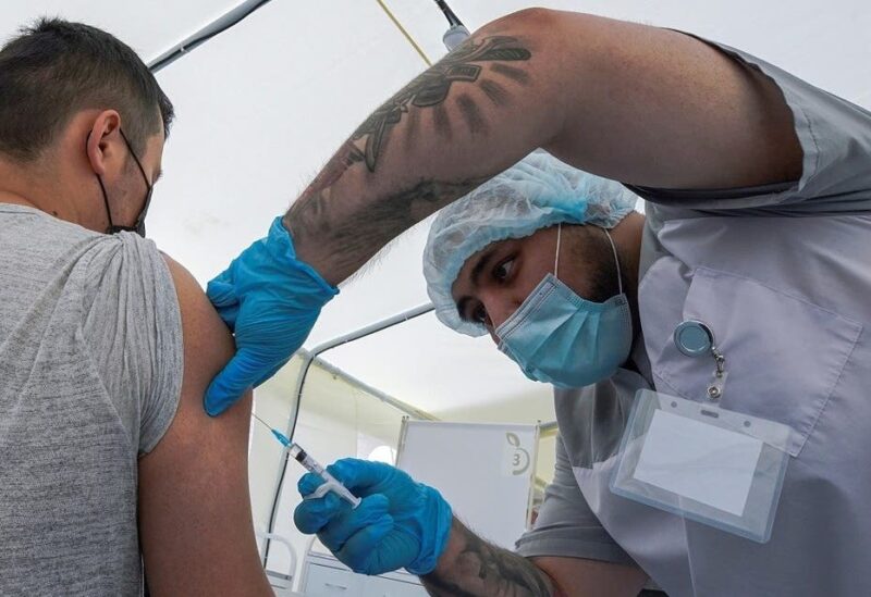 A migrant worker receives a jab while being injected with the one-dose Sputnik Light vaccine against the coronavirus in a vaccination center at a city market in Moscow, Russia. (File photo: Reuters)