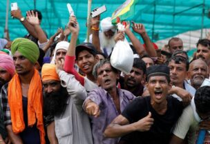 People shout slogans during a Maha Panchayat or grand village council meeting as part of a farmers' protest against farm laws in Muzaffarnagar in the northern state of Uttar Pradesh, India, September 5, 2021. (Reuters)