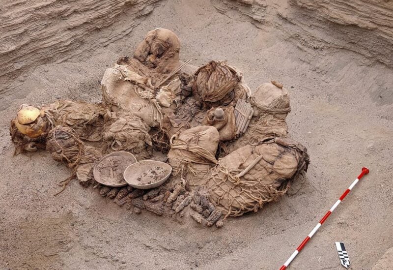 Handout picture released by Peruvian gas company Calidda, shows objects, food, artifacts and ancient funeral bundles containing the remains of 8 inhabitants who where uncovered by workers of the gas distributing company Calidda. (AFP)