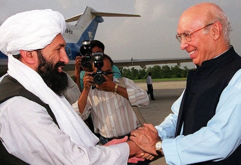 File photo of Afghan Taliban foreign minister Mulla Mohammad Hassan Akhund (L) at an Air Force base in Rawalpindi, some 25 kilometers from Islamabad, meeting his Pakistani counterpart Sartaj Aziz on August 24, 1999. (AFP)