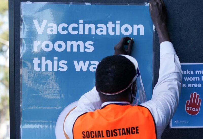 A staff member straightens a sign outside a coronavirus disease (COVID-19) vaccination clinic at the Bankstown Sports Club as the city experiences an extended lockdown, in Sydney, Australia, August 3, 2021. (File photo: Reuters)
