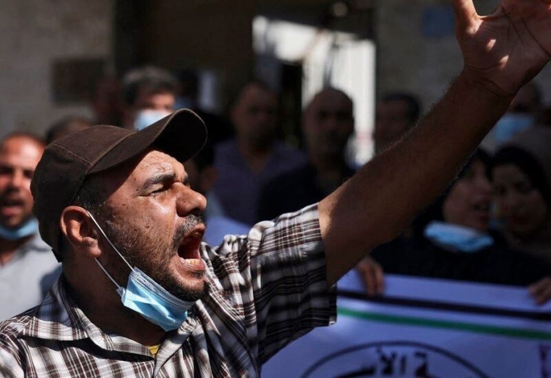 Palestinians chant slogans during a rally next to the Red Cross building in Gaza City in support of more than a thousand prisoners who are in Israeli jails, on September 9, 2021. (Mohammed Abed/AFP)