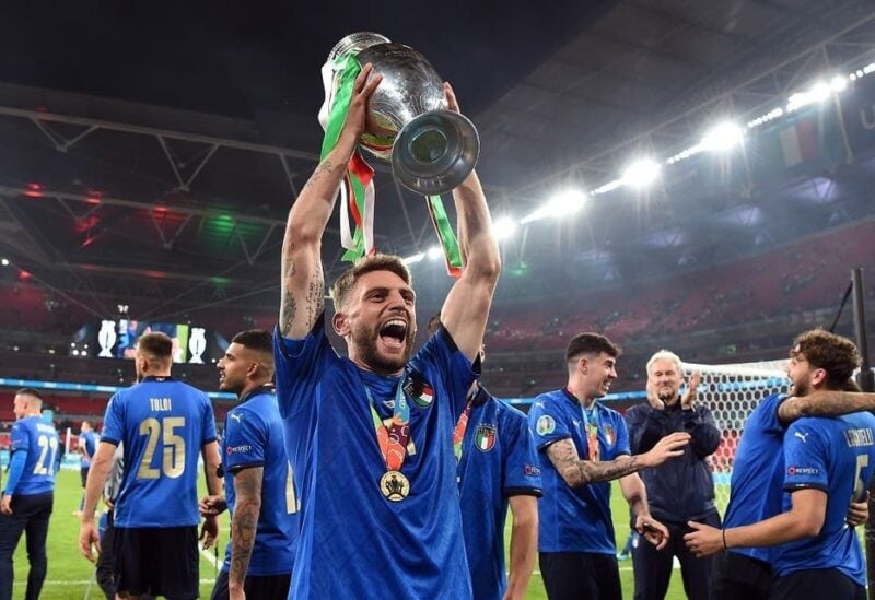 Italy's Domenico Berardi celebrates with the trophy after winning Euro 2020 with teammates. (Reuters)