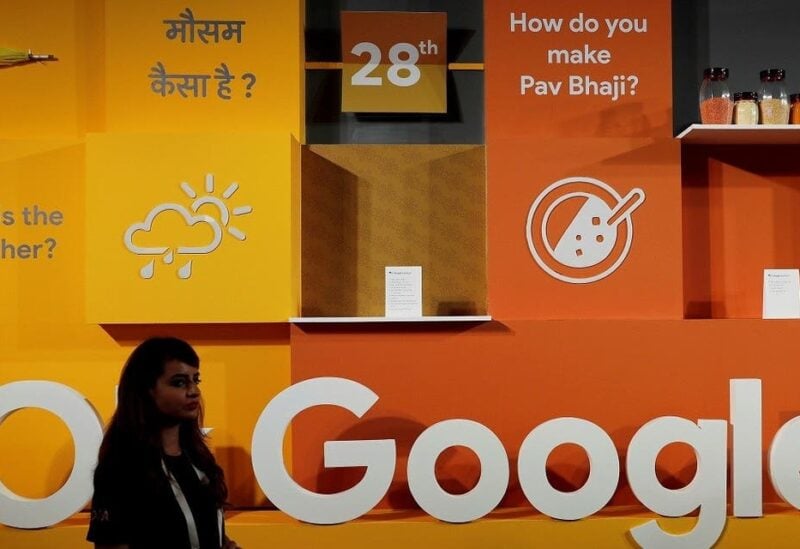 A woman walks past the logo of Google during an event in New Delhi, India. (Reuters)