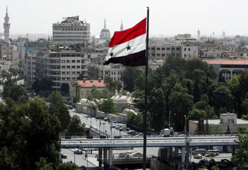 A Syrian flag flutters in Damascus on April 20, 2018