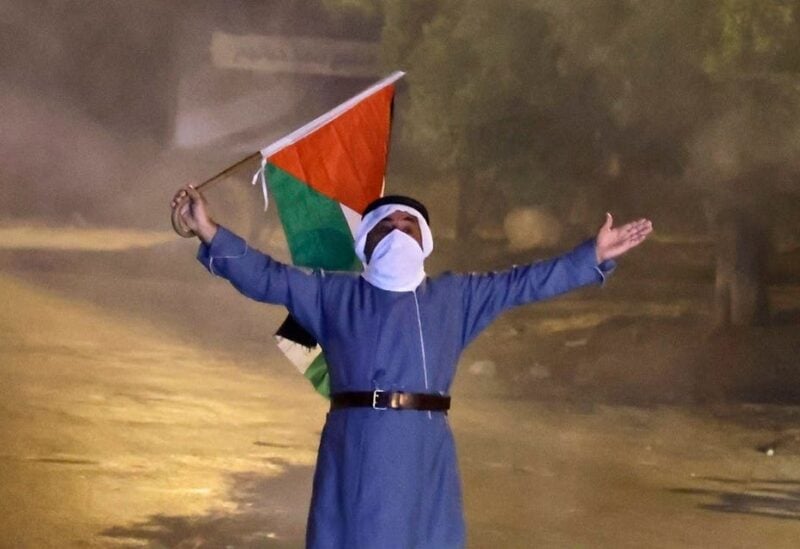 Palestinian raising the flag