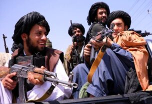 Taliban forces patrol in front of Hamid Karzai International Airport in Kabul, Afghanistan