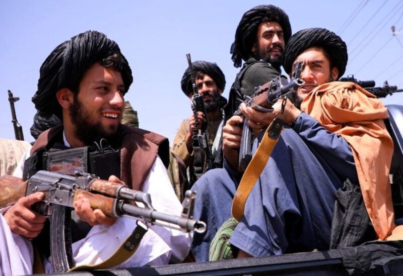 Taliban forces patrol in front of Hamid Karzai International Airport in Kabul, Afghanistan