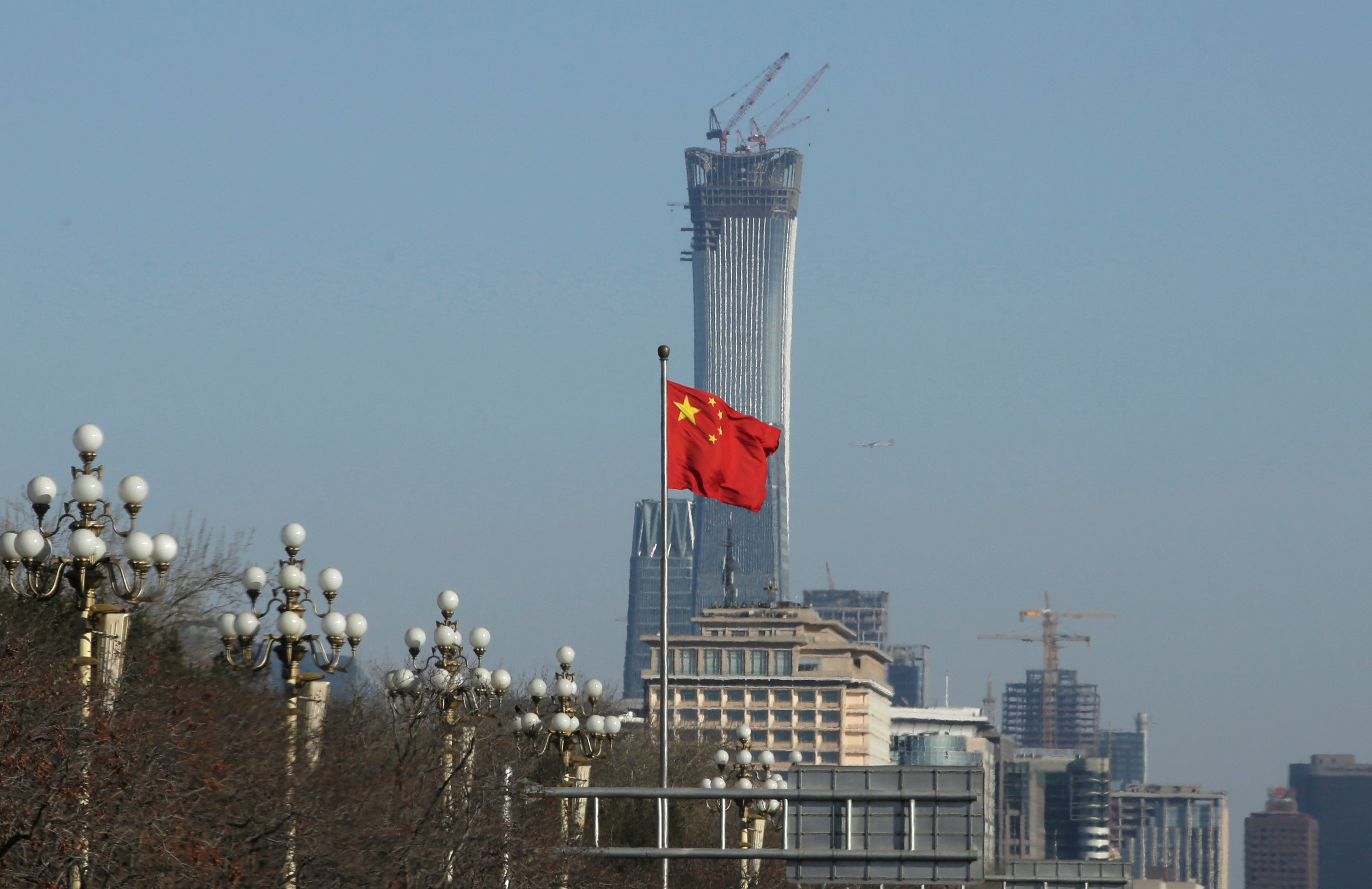FILE PHOTO: A Chinese flag flutters at Xinhuamen Gate of Zhongnanhai leadership compound in central Beijing, China December 15, 2017. REUTERS/Jason Lee