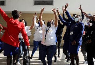 Workers sing and dance as a South African Airways (SAA) airplane prepares to take off after a year-long hiatus triggered by the national airline running out of funds, at O.R. Tambo International Airport in Johannesburg, South Africa, on September 23, 2021. (Reuters)