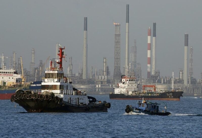 Vessels pass an oil refinery in the waters off the southern coast of Singapore. (Reuters)