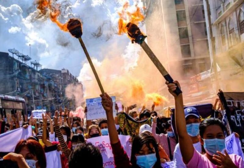 A group of women hold torches as they protest against the military coup in Yangon, Myanmar