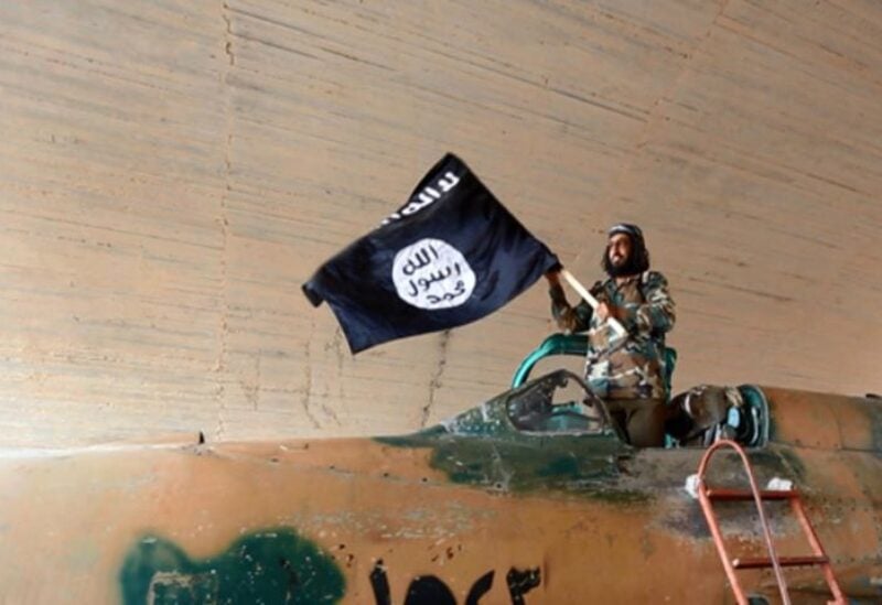 A member loyal to ISIS waves the ISIS flag in Raqqa, Syria