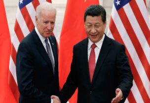 Chinese President Xi Jinping shakes hands with then-U.S. Vice President Joe Biden