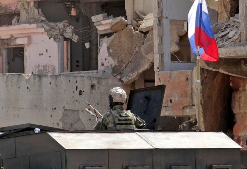 A picture shows Russian troops in the Syrian district of Daraa al-Balad in Syria's southern province of Daraa