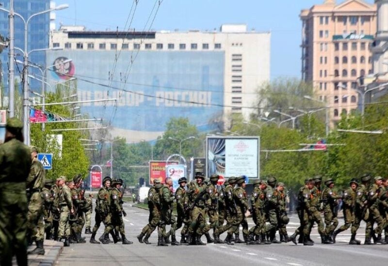 Russia-backed rebel soldiers cross a street during a rehearsal for the Victory Day military parade in Donetsk, Ukraine
