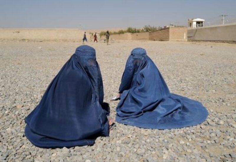 FILE PHOTO: Displaced Afghan women wait to receive aid supply from UNHCR agency outside the distribution center on the outskirts of Kabul, Afghanistan October 28, 2021. REUTERS/Zohra Bensemra/File Photo