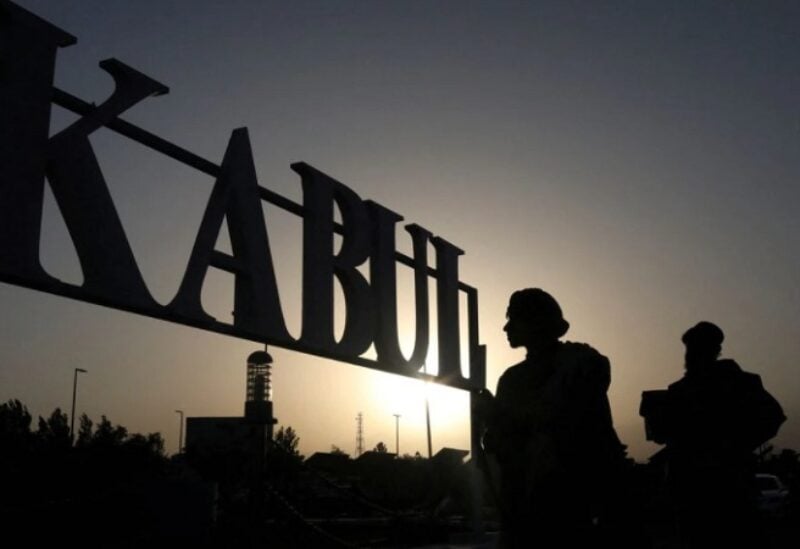 Taliban soldiers stand in front of a sign at the international airport in Kabul, Afghanistan, September 9, 2021. WANA (West Asia News Agency) via REUTERS