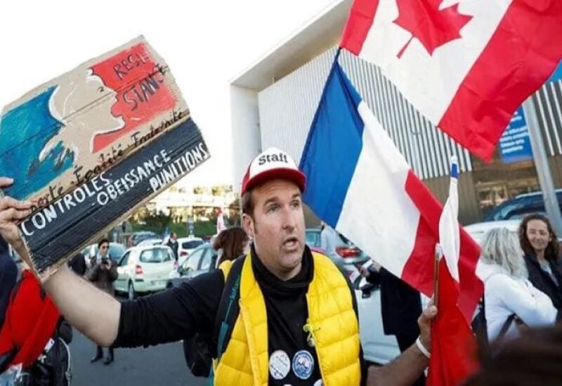 A French activist holds a Canadian flag