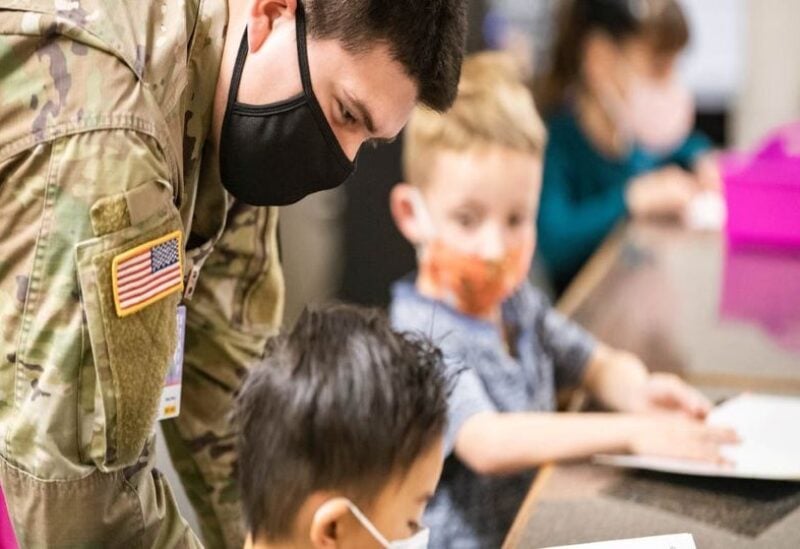Army Specialist Mario Meraz, with the New Mexico Army National Guard, teaches kindergarten at Highland Elementary School in Las Cruces on Wednesday, Februay 9, 2022