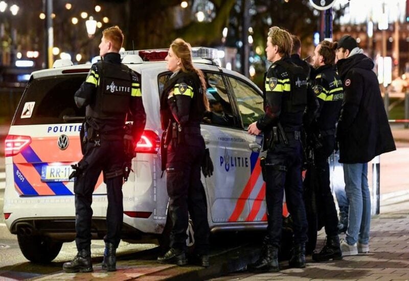 Dutch police officers stand near an Apple store in central Amsterdam during a hostage incident in the store, in Amsterdam, Netherlands