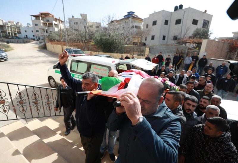 Palestinian relatives mourn during the funeral of Omar Abdalmajeed Asaad