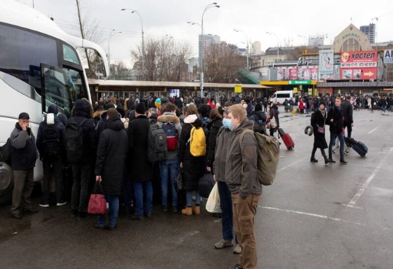 People gather at a bus station as they try to leave the city of Kyiv, Ukraine February 24, 2022