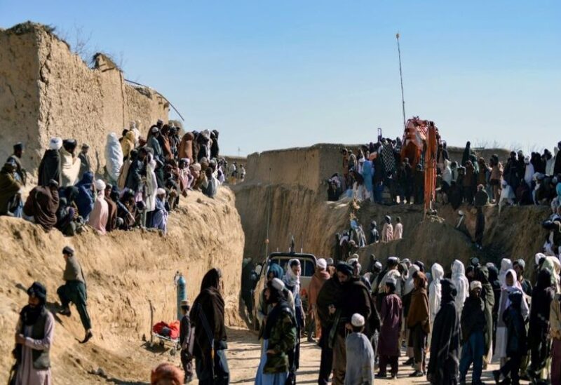 People in Afghanistan gather as rescuers try to reach and rescue a boy trapped for days down a well in a remote southern Afghan village of Shokak
