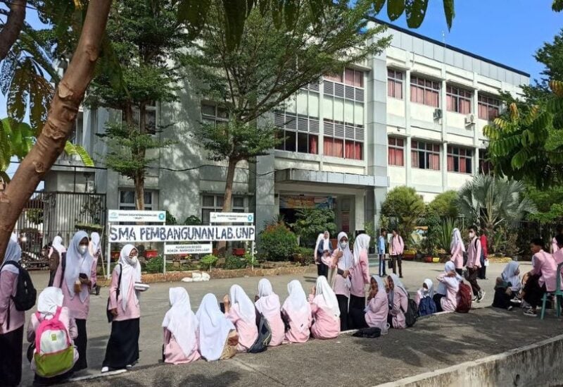 Primary school students evacuate from the school building after a 6.2 magnitude earthquake in Sumatra Island, Indonesia, February 25, 2022