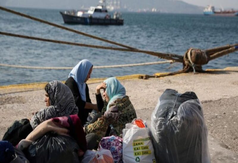 Refugees and migrants arrive aboard the Paros Jet passenger ship at the port of Elefsina near Athens, Greece