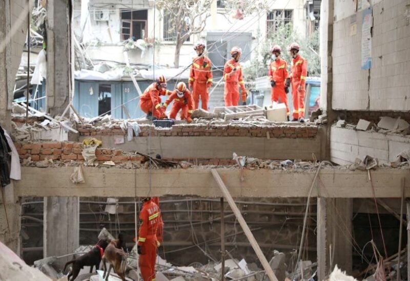 Rescue workers search for victims amid the debris following a gas pipeline explosion in Shiyan, Hubei province, China