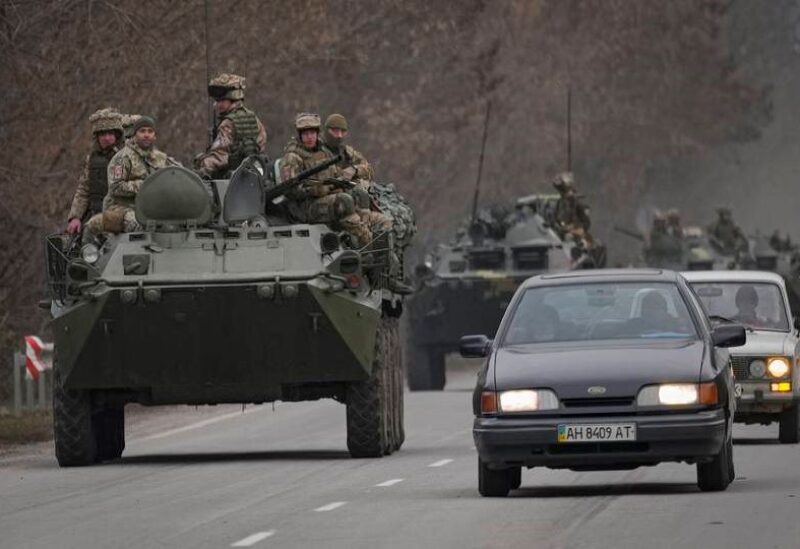 Ukrainian servicemen sit atop tanks in the Donetsk region, eastern Ukraine