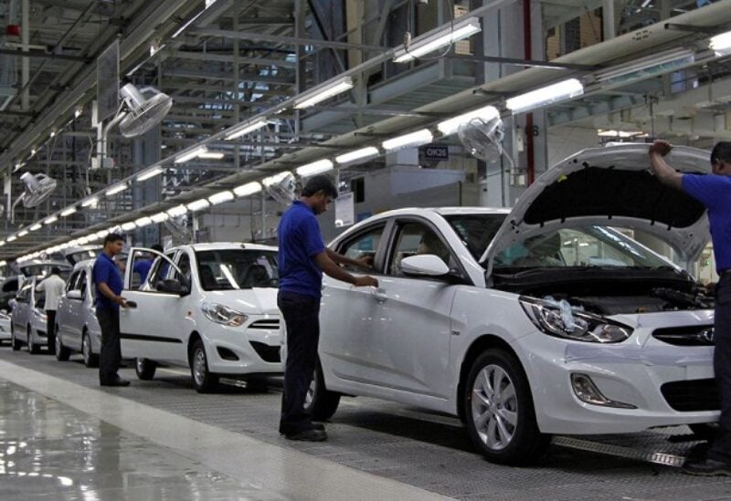 Workers assemble cars inside the Hyundai Motor India