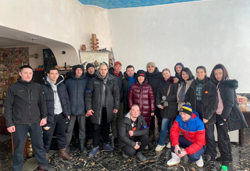 Local resident Teimur Aliev poses with his team of volunteers that deliver food and aid, amid the Russian invasion, in Kharkiv, Ukraine