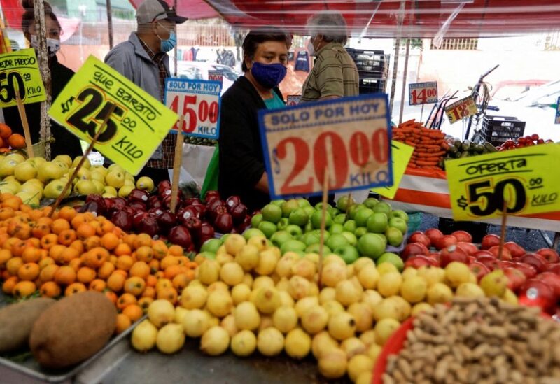Customers walk past a fruit stall at a street market, in Mexico City, Mexico