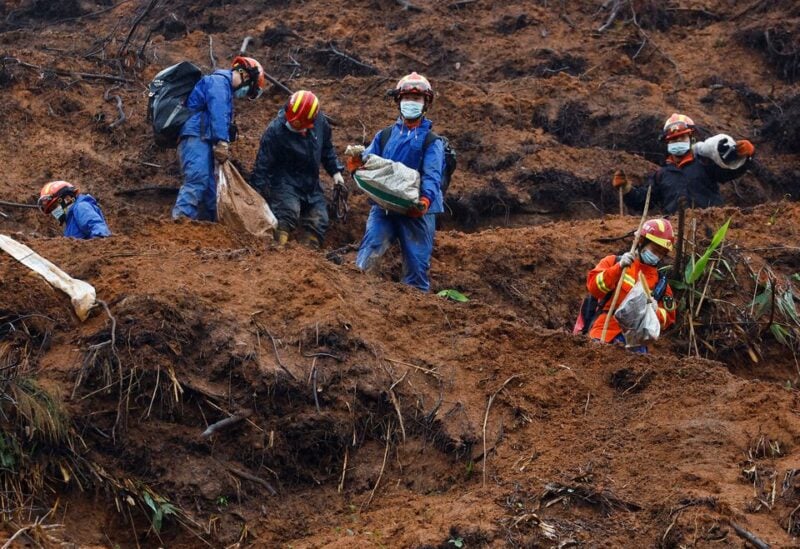 Rescue workers work at the site where a China Eastern Airlines Boeing 737-800 plane flying from Kunming to Guangzhou crashed