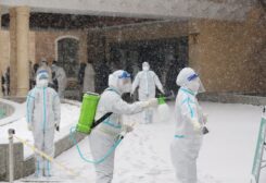 Workers in protective suits disinfect themselves amid the snow at a nucleic acid testing site, following the coronavirus disease (COVID-19) outbreak in Changchun, Jilin province, China March 15, 2022.
