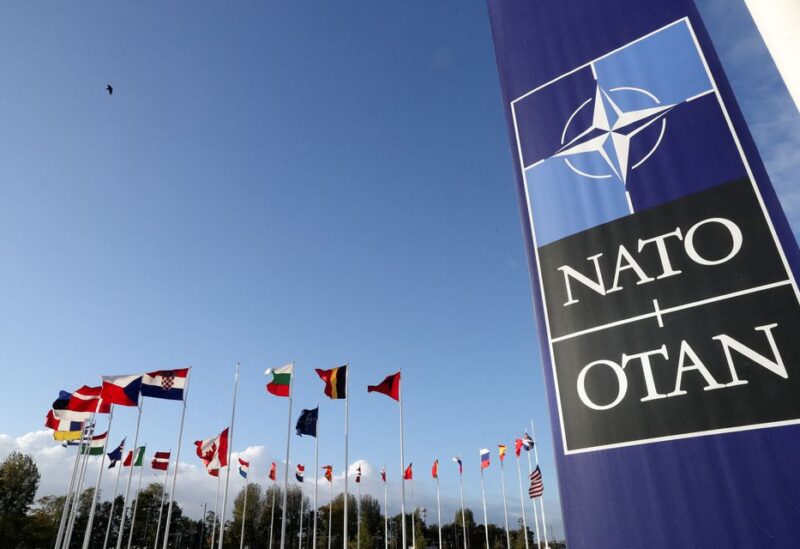 Flags wave outside the Alliance headquarters ahead of a NATO Defence Ministers meeting, in Brussels