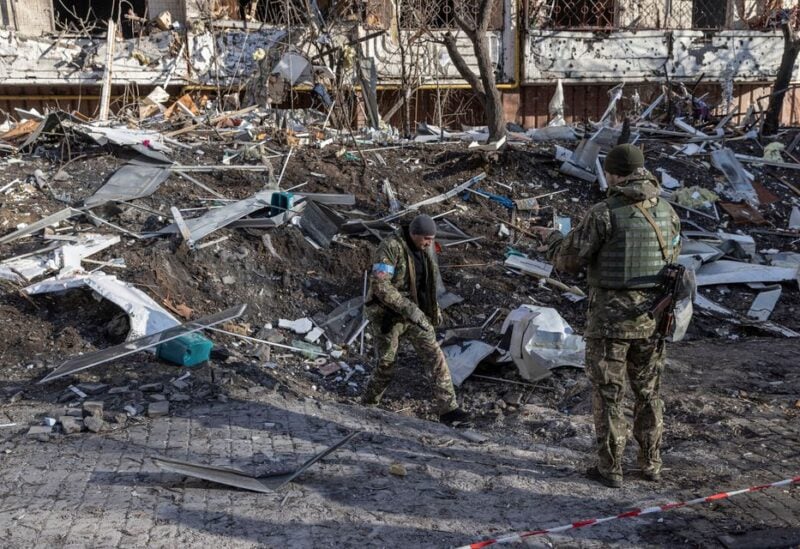 Ukrainian servicemen inspect the area in front of a residential apartment building after it was hit by shelling as Russia's invasion of Ukraine continues, in Kyiv, Ukraine, March 15, 2022.